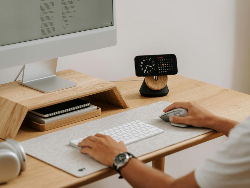 Minimalist desk setup with a glass of water and sunlight.