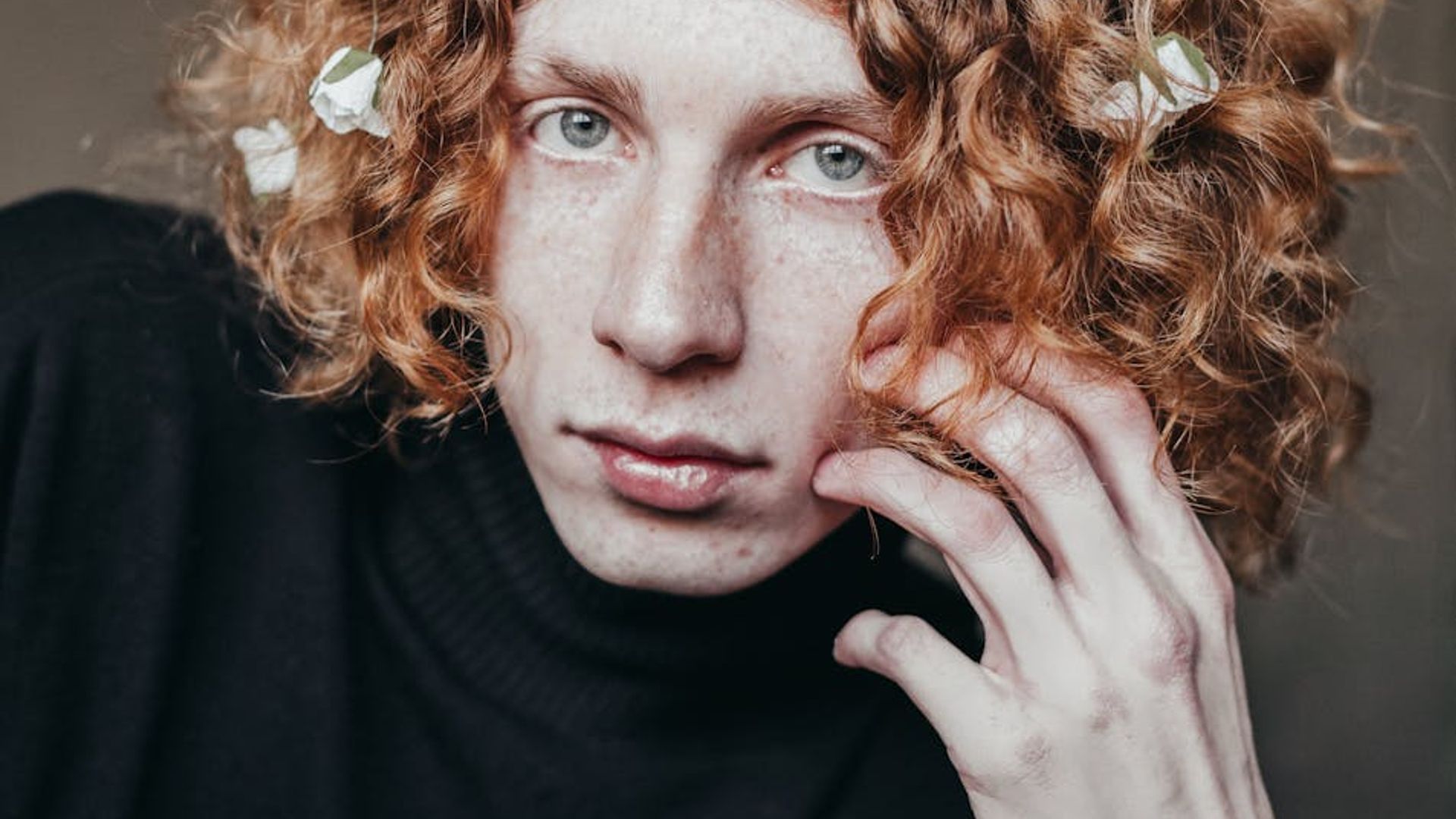 Person looking at a bright window with a calm expression.